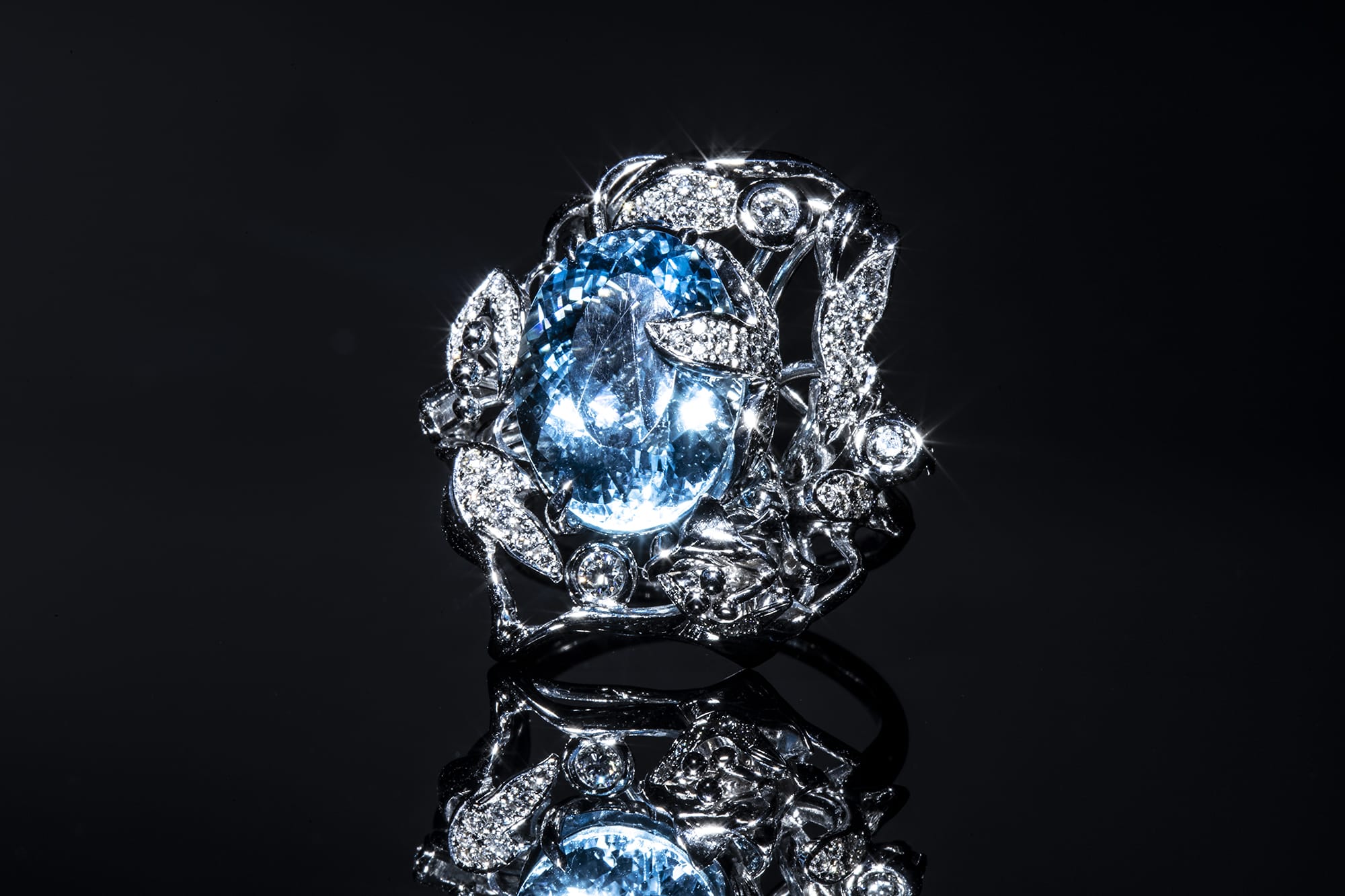 Light blue gemstone with triangular diamonds